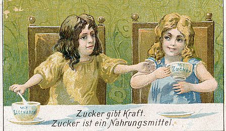 Zeichnung zweier Mädchen mit zwei Tassen. Darunter der Schriftzug: "Zucker gibt Kraft. Zucker ist ein Nahrungsmittel."