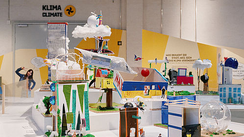 Farbenfrohe Modelle von einer „Stadt der Zukunft“ bilden das Zentrum der Ausstellung in der Ladestraße des Museums.