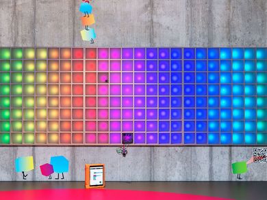 Die Pixelwand leuchtet in Regenbogenfarben.