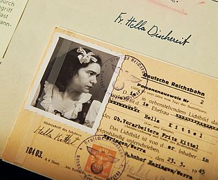 A Reichsbahn identity card with the photo of a dark-haired woman issued in the name of "Hella Kittel, wife of Gb. foreman Fritz Kittel" dated 23.03.1945.